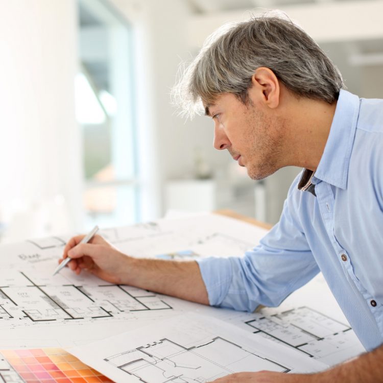 An architect drawing up plans for a villa in Spain