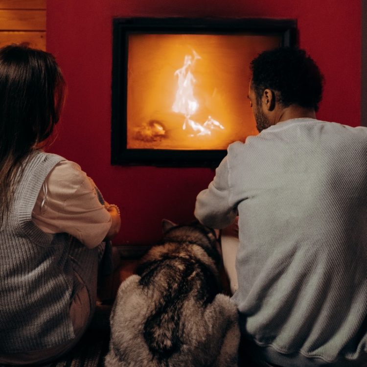 Couple in front of open fire